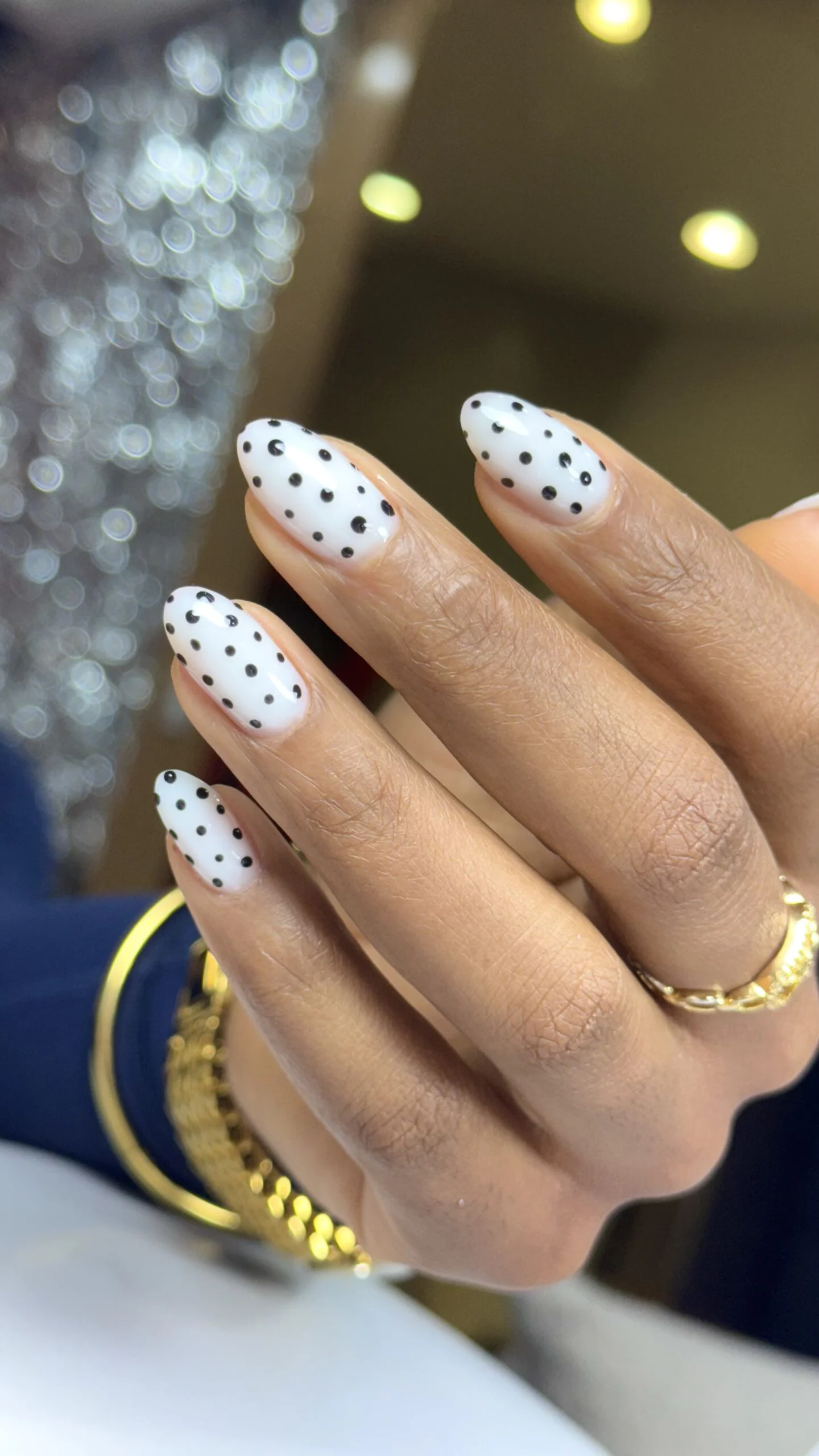 White nails with black polka dots by Ruta Beauty
