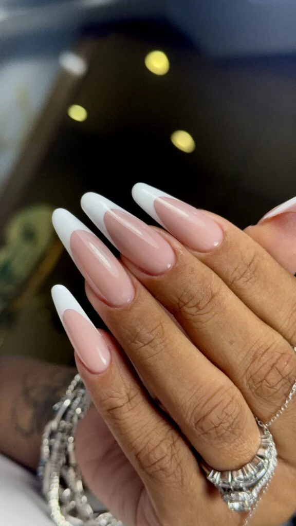 Long almond white French manicure by Ruta Beauty
