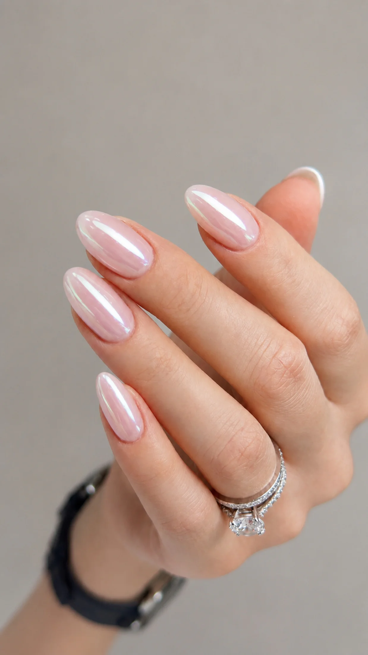 Soft pearl chrome almond manicure with a glossy pink finish