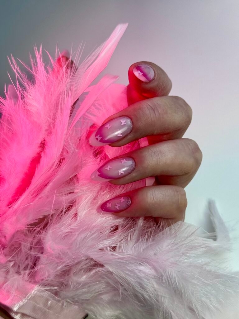 Pink butterfly nail art with a soft ombre finish by Ruta Beauty
