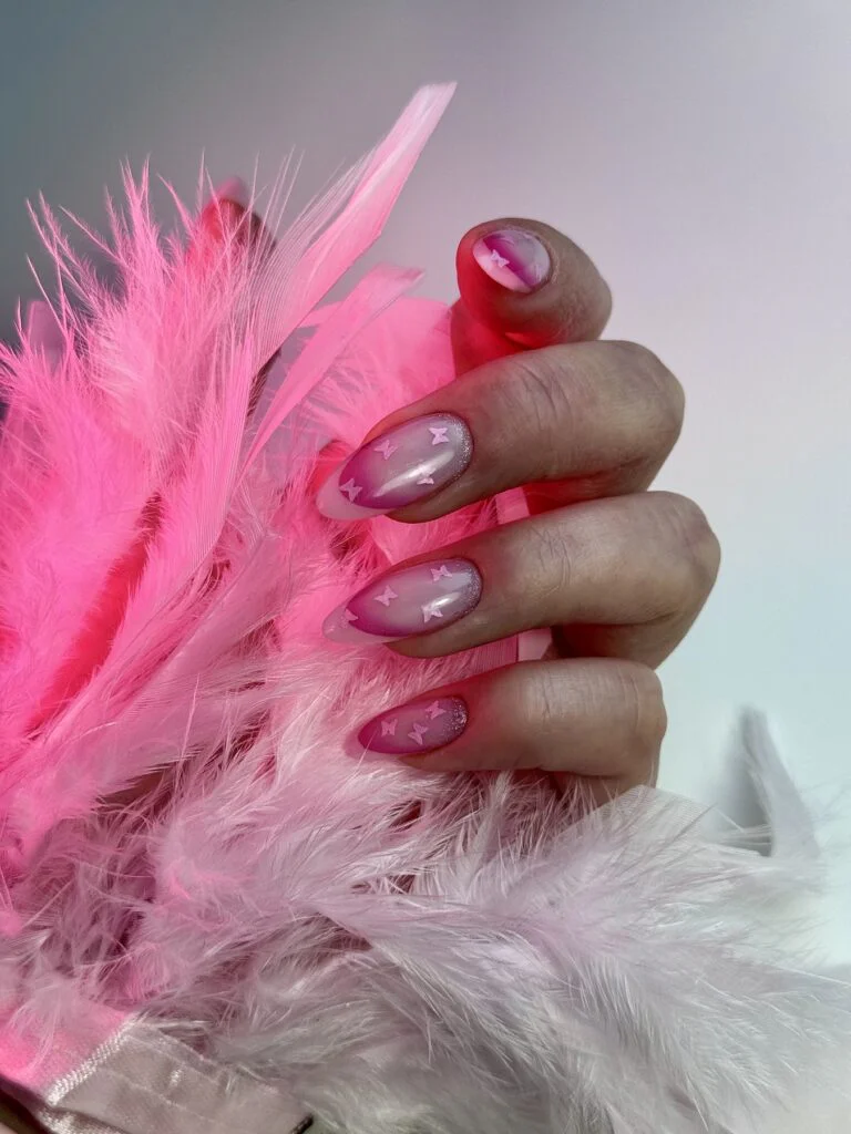 Pink butterfly nail art with a soft ombre finish by Ruta Beauty